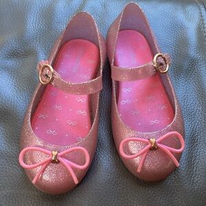 Mini Melissa’s 10 pink glitter thin little bow gold accents, rubber jelly shoes